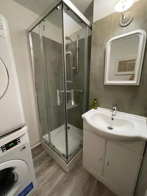 a bathroom with a glass shower and a sink at la maison des chapeliers in Carcassonne