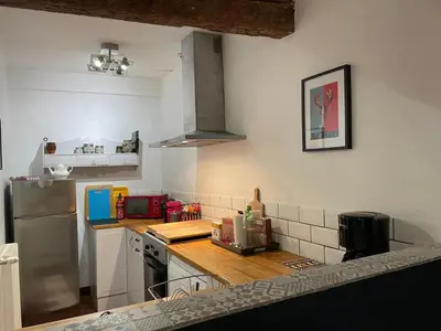 a kitchen with a refrigerator and a counter top at la maison des chapeliers in Carcassonne