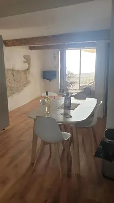 a white table and chairs in a living room at Gîtes Les 3 Tours in Carcassonne