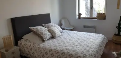 a bedroom with a bed with pillows and a window at Gîtes Les 3 Tours 2 in Carcassonne