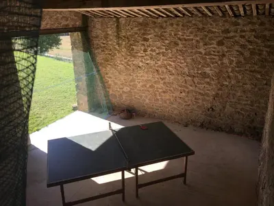 a table in a room with a brick wall at Maison vigneronne in Montlaur