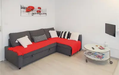 a living room with a couch and a table at Nice Apartment In Gruissan With Kitchen in Gruissan