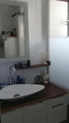 a bathroom with a white sink and a mirror at Chambre avec petit déjeuner in Carcassonne