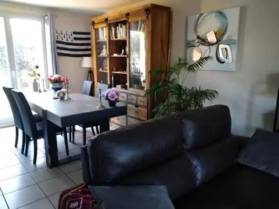 a living room with a couch and a table at Chambre avec petit déjeuner in Carcassonne