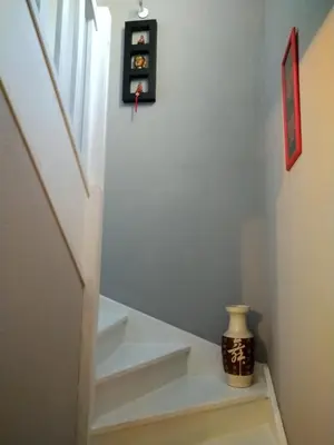a stairway with white steps and a window at Chambre avec petit déjeuner in Carcassonne