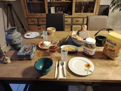 a table topped with plates and bowls of food at Chambre avec petit déjeuner in Carcassonne