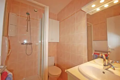 a bathroom with a shower and a sink and a toilet at Grand studio la Presqu'île 2 in Gruissan