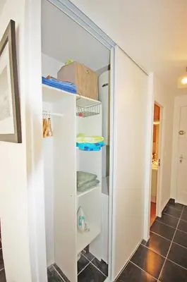 a walk in closet with white walls and shelves at Grand studio la Presqu'île 2 in Gruissan