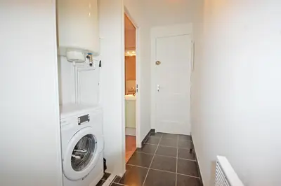 a laundry room with a washer and dryer at Grand studio la Presqu'île 2 in Gruissan