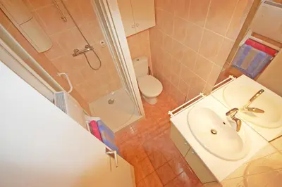a bathroom with a sink and a shower and a toilet at Grand studio la Presqu'île 2 in Gruissan