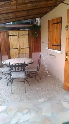 a patio with a table and chairs in a room at Le Refuge in Puivert