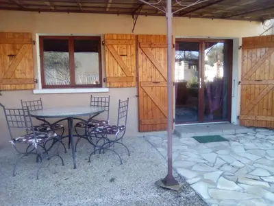 a table and chairs in front of a house at Le Refuge in Puivert