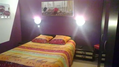 a bedroom with a bed and two lights on the wall at Le Refuge in Puivert