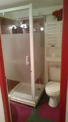 a bathroom with a toilet and a glass shower at Le Refuge in Puivert