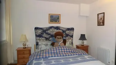 a bedroom with a teddy bear sitting on a bed at Gite Charlrose at La Platriere in Cazedarnes