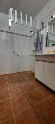 a bathroom with a shower and a tile floor at Gite Charlrose at La Platriere in Cazedarnes