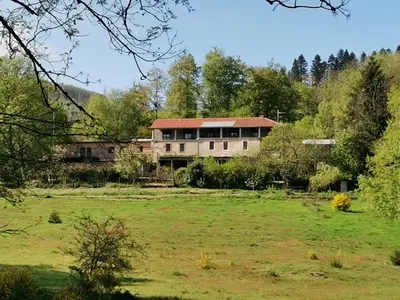 a large house in the middle of a field at La Bouriotte, chambre d'hôtes Sycomore, in Labastide-Rouairoux