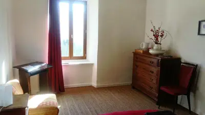 a living room with a dresser and a window at La Bouriotte, chambre d'hôtes Sycomore, in Labastide-Rouairoux