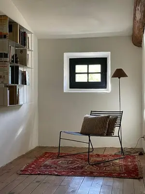 a bench sitting in a room with a window at La Maison Du Village in Val-de-Dagne