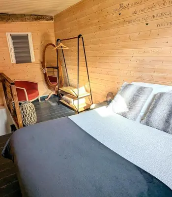 a bedroom with a bed and a swing at Appartement Lila in Carcassonne