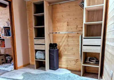a closet with wooden walls and wooden shelves at Appartement Lila in Carcassonne