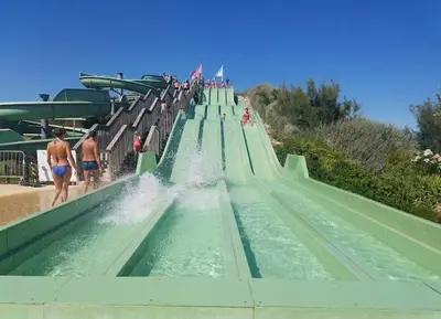a long water slide at a water park at Duplex Climatisé 65m2 refait à neuf in Gruissan