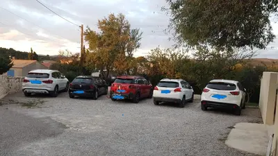 a group of cars parked in a parking lot at chambres d'hôtes du moulin in Peyriac-de-Mer
