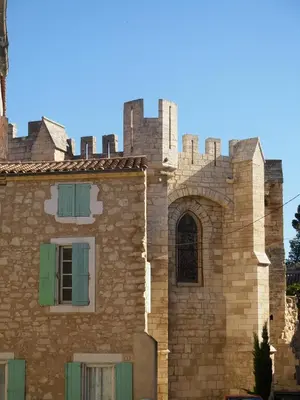 an old brick building with a window and turrets at chambres d'hôtes du moulin in Peyriac-de-Mer