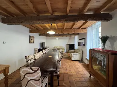 a large dining room with a long table and chairs at Gîte tout Confort au Coeur du Village Verniolle in Verniolle