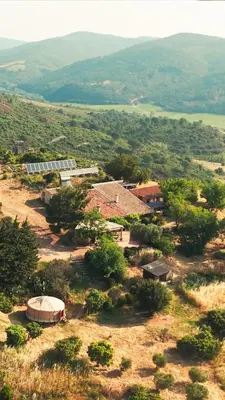 an aerial view of a house on a hill with mountains at Chambres d'hôtes Gîte Saint Roch in Tuchan