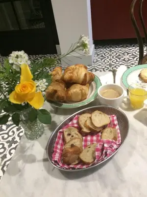 a table with two plates of food and a plate of pastries at La Grande Maison in Cambieure