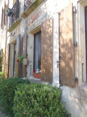 a building with wooden doors on the side of it at La Grande Maison in Cambieure