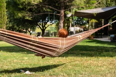 a person laying in a hammock in a park at La Segonne in Montréal
