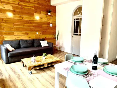 a living room with a couch and a table at Just Like home in Carcassonne in Carcassonne