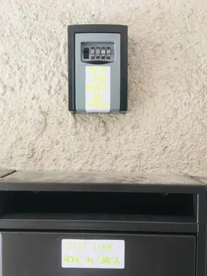 a pay meter with a sign on the side of a wall at Just Like home in Carcassonne in Carcassonne