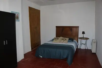 a bedroom with a bed with two pillows on it at Maison près Cité de Carcassonne in Villalier