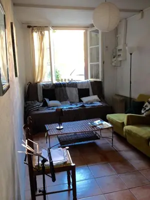 a living room with a couch and a table at Maison près Cité de Carcassonne in Villalier