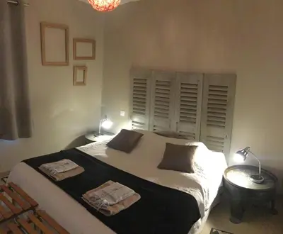 a bedroom with a bed with two towels on it at Gîte Chez Les Brocs in Canet d'Aude