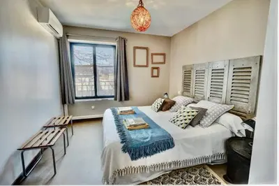 a bedroom with a large bed and a window at Gîte Chez Les Brocs in Canet d'Aude