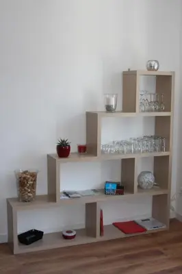 a wooden shelf with glasses on it on a wall at Gîte les 3 tours 1e étage in Carcassonne