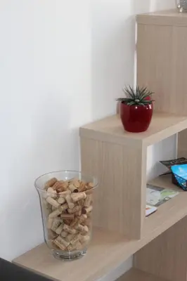 a glass vase filled with rocks on a shelf at Gîte les 3 tours 1e étage in Carcassonne