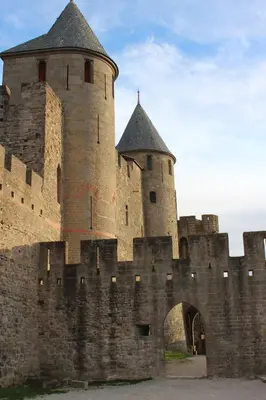 a large medieval castle with a gate and a tower at Gîte les 3 tours 1e étage in Carcassonne