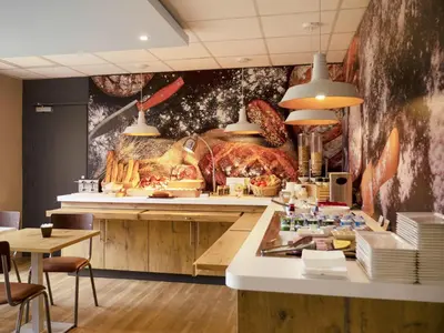 a kitchen with a turkey on the wall at ibis Carcassonne Centre - La Cité in Carcassonne