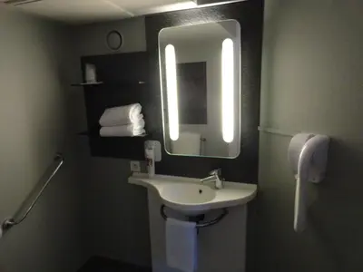 a bathroom with a sink and a mirror at ibis Carcassonne Centre - La Cité in Carcassonne