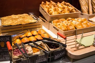 a bakery with various types of bread and pastries at ibis Carcassonne Centre - La Cité in Carcassonne
