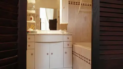a bathroom with a sink and a mirror and a tub at LA LOUISIANE 31 in Villefranche-de-Lauragais