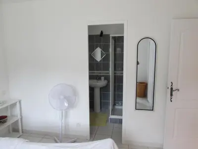 a white bathroom with a sink and a mirror at Maison Minervois in Agel