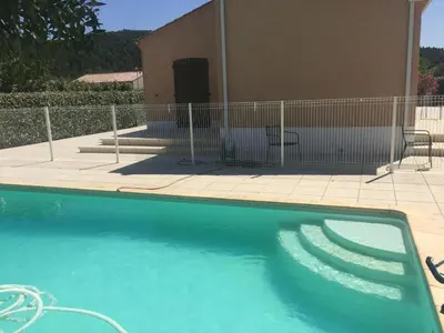 a swimming pool in front of a house at Maison Minervois in Agel