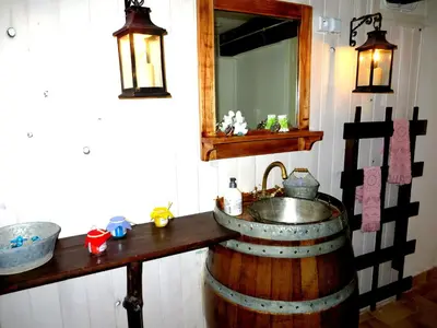 a bathroom with a sink and a mirror on a barrel at cote de la cite medievale in Carcassonne