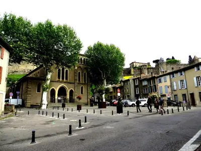 a group of people walking down a city street at cote de la cite medievale in Carcassonne